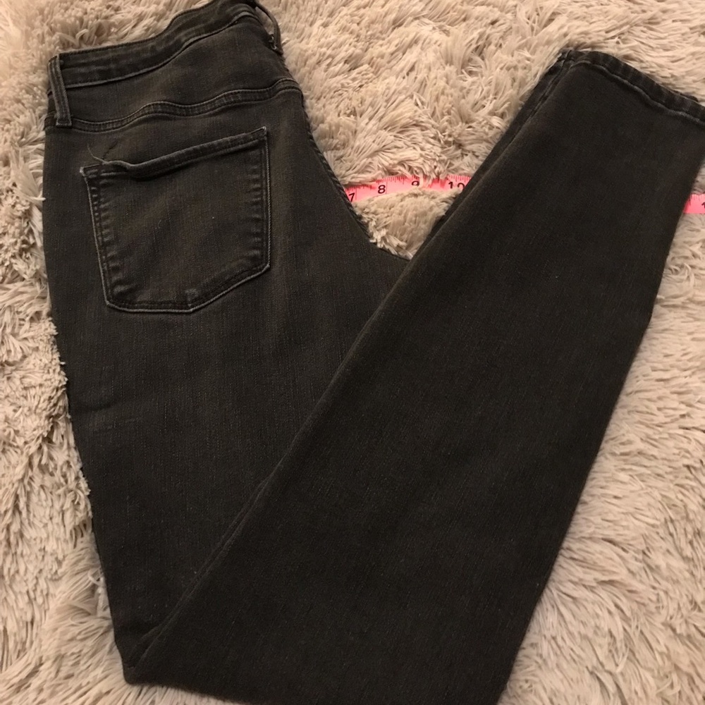 Distressed black straight jeans.